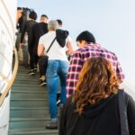 group of people on stairs under clear white sky