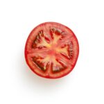 sliced tomato on white surface