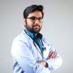 man in white dress shirt wearing black framed eyeglasses