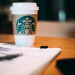 selective focus photography of Starbucks coffee cup