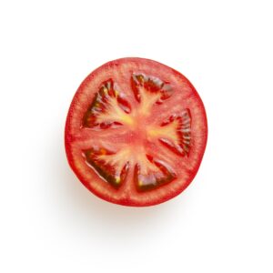 sliced tomato on white surface